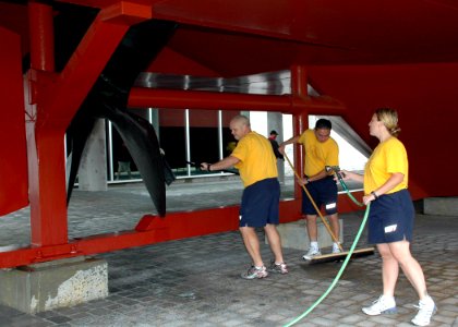 US Navy 090910-N-5292M-606 Personel Specialist 1st class, chief select, Andy Hick scrubs the propeller of the ironclad replica of the USS Monitor at the Mariners' Museum in Newport News, Va