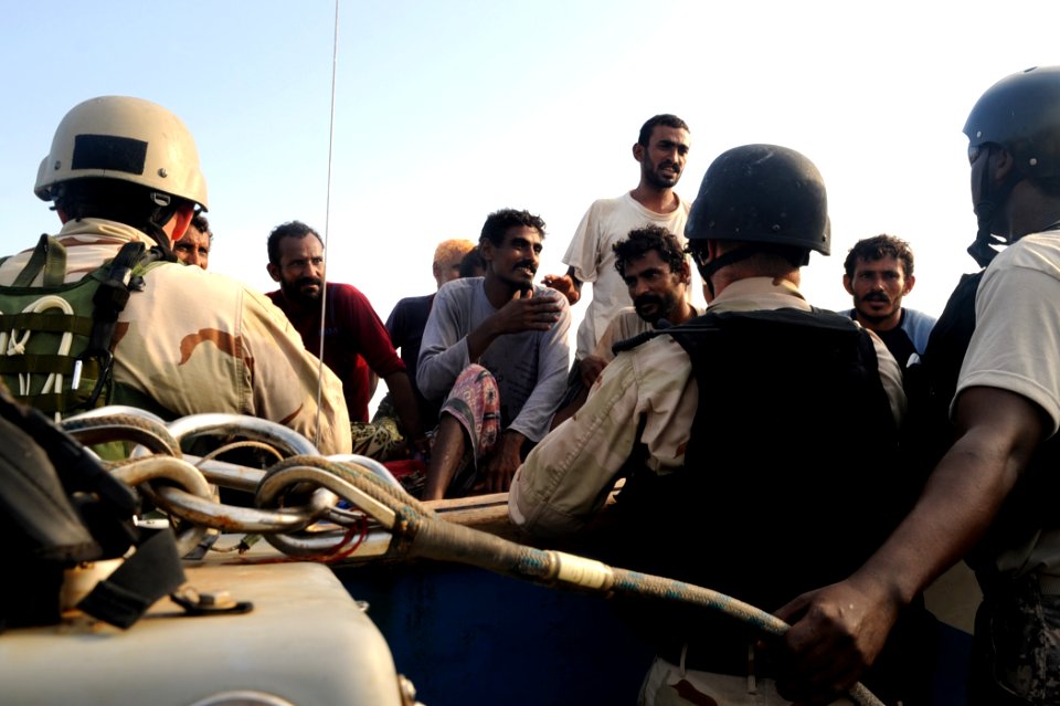 US Navy 090910-N-6814F-103 Yemeni fishermen greet a Navy and U.S. Coast Guard visit, board, search, and seizure team during a right-of-visit boarding near the guided-missile cruiser USS Anzio (CG 68)
