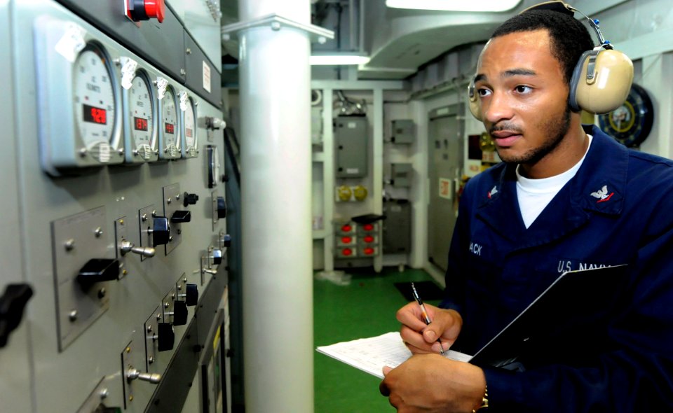 US Navy 090911-N-7280V-361 Engineman 3rd Class Calvin Mack, assigned to the amphibious command ship USS Blue Ridge (LCC 19), takes switchboard readings of the ship's service diesel generator
