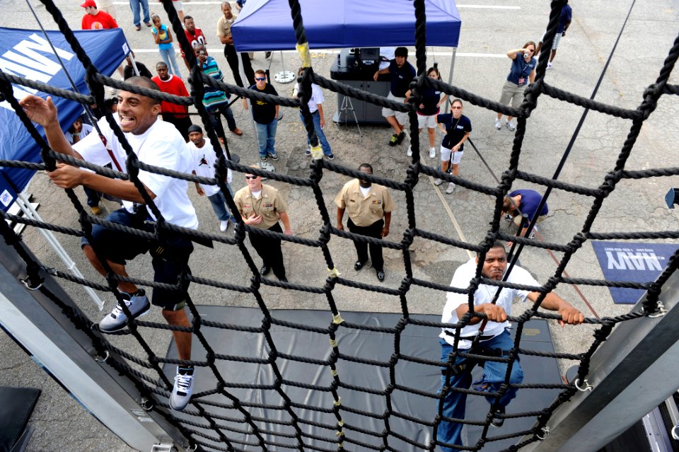 US Navy 090912-N-0555B-211 Tyrell Jones, left, from Memphis, Tenn., races to the top of a rope ladder at the Navy SEAL Accelerator
