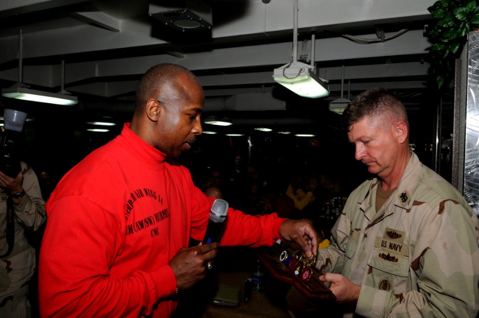 US Navy 090912-N-3610L-127 Joseph Murphy, command master chief of Carrier Air Wing (CVW) 14 presents an air wing coin to Master Chief Perry Officer of the Navy (MCPON)