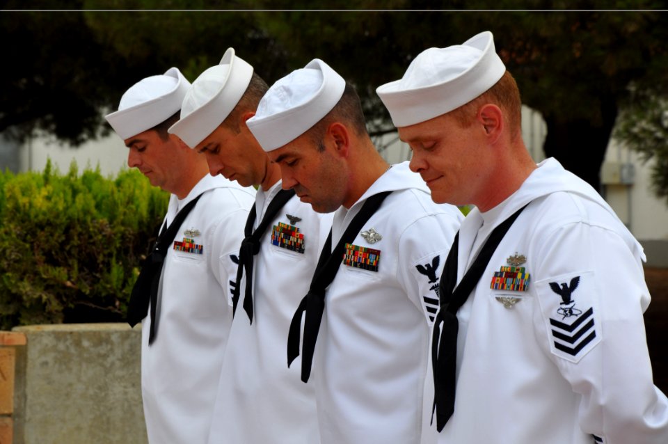 US Navy 090911-N-1825E-010 Chief petty officer selects assigned to Naval Station Rota stand in prayer during a flag retirement ceremony photo