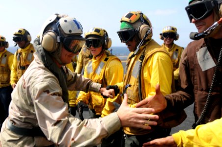 US Navy 090912-N-9132C-100 Sailors greet Master Chief Petty Officer of the Navy (MCPON) Rick West during his arrival aboard the aircraft carrier USS Ronald Reagan (CVN 76)