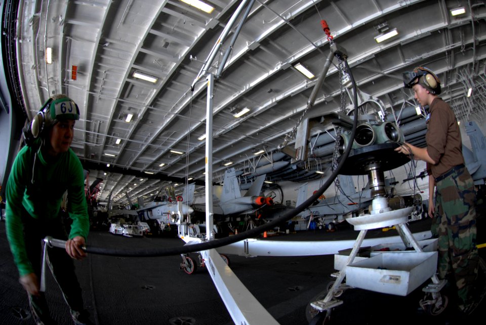 US Navy 090914-N-2600H-003 Aviation Machinist's Mate Airman Katherine Knipfer and Aviation Machinist's Mate 1st Class Jason Nieva, prepare to re-install the propeller assembly of an E-2C Hawkeye