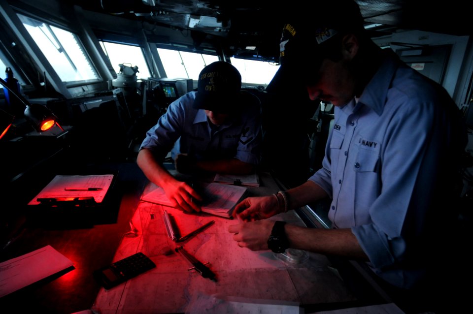 US Navy 090911-N-9132C-047 Quartermaster Seaman Christopher Madden plots a chart at the navigation table on the bridge of the aircraft carrier USS Ronald Reagan (CVN 76)