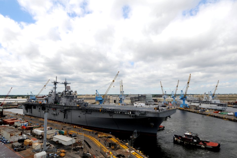 US Navy 090911-N-9774H-106 The amphibious assault ship USS Kearsarge (LHD 3) is towed out of a Norfolk Naval Shipyard dry dock to a pierside berth