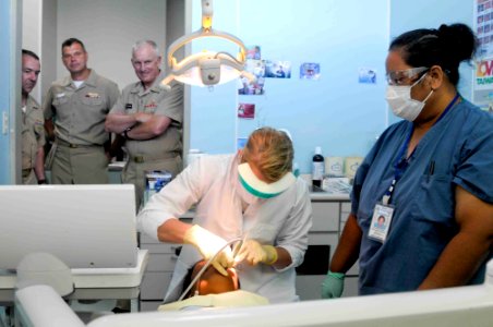 US Navy 090911-N-9689V-003 Rear Adm. Thomas Cullison, deputy surgeon general, observes Royal Australian Air Force Cpl. Diane Beningfield as she treats a patient during a Pacific Partnership 2009 medical civic action project
