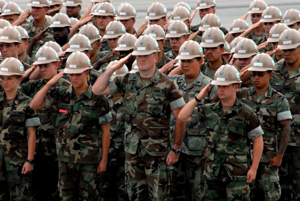 US Navy 090911-N-3289C-180 Seabees assigned to Naval Mobile Construction Battalion (NMCB) 3 salute the national ensign during a Sept. 11 memorial service