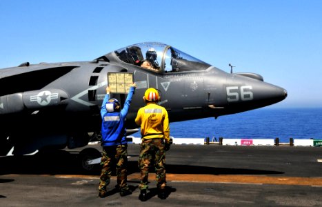 USS Bataan Sailors hold up a tote board to communicate with the pilot of an AV-8B Harrier (5957538249)