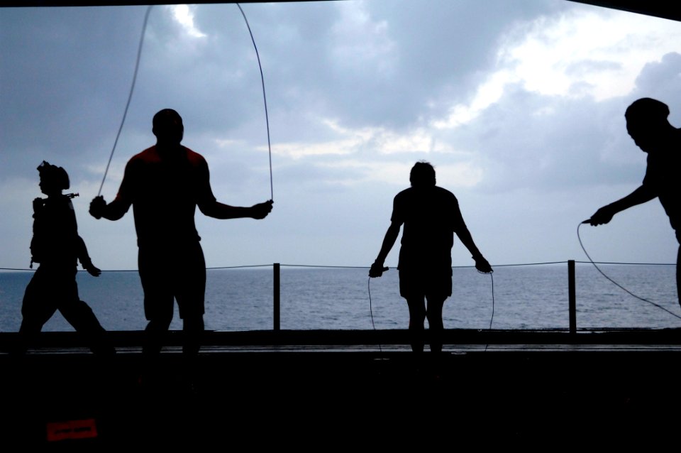 US Navy 090913-N-9818V-051 Sailors aboard the aircraft carrier USS Ronald Reagan (CVN 76) conduct morning physical training in the hangar bay of the ship