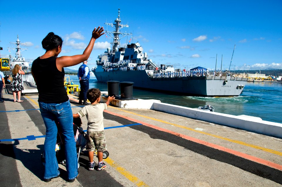 US Navy 090914-N-6674H-006 Family members wave as the guided-missile destroyer USS Hopper (DDG 70) departs Naval Station Pearl Harbor for a scheduled deployment to the U.S. 5th Fleet area of responsibility