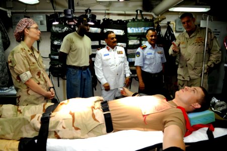 US Navy 090912-N-6814F-202 Rear Adm. Scott E. Sanders explains a medical training exercise to Col. Lofta Al Barati and Brig. Gen. Shamshan Radhan during a visit aboard the guided-missile cruiser USS Anzio (CG 68)