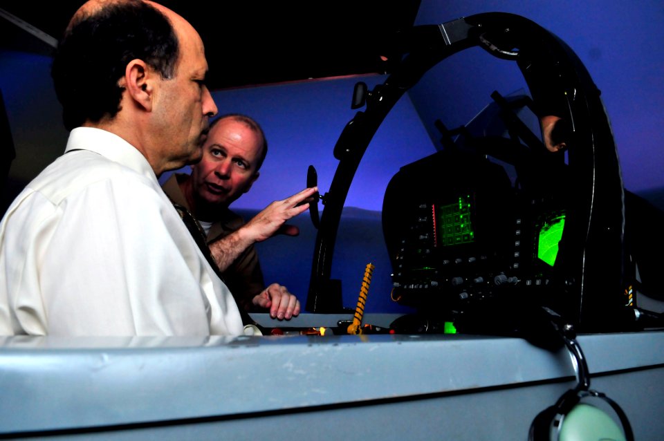 US Navy 090915-N-4031K-052 Capt. Ross Myers, right, commander of Carrier Air Wing (CVW) 5, explains the F-A-18 simulator to U. S. Ambassador to Japan the Honorable John Roos