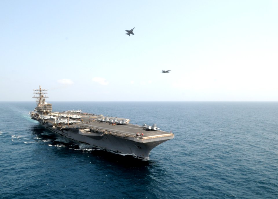 US Navy 090912-N-1635S-095 Two F-A-18E Super Hornets assigned to the Eagles of Strike Fighter Squadron (VFA) 115 perform an airborne change of command above the Nimitz class aircraft carrier USS Ronald Reagan (CVN 76)
