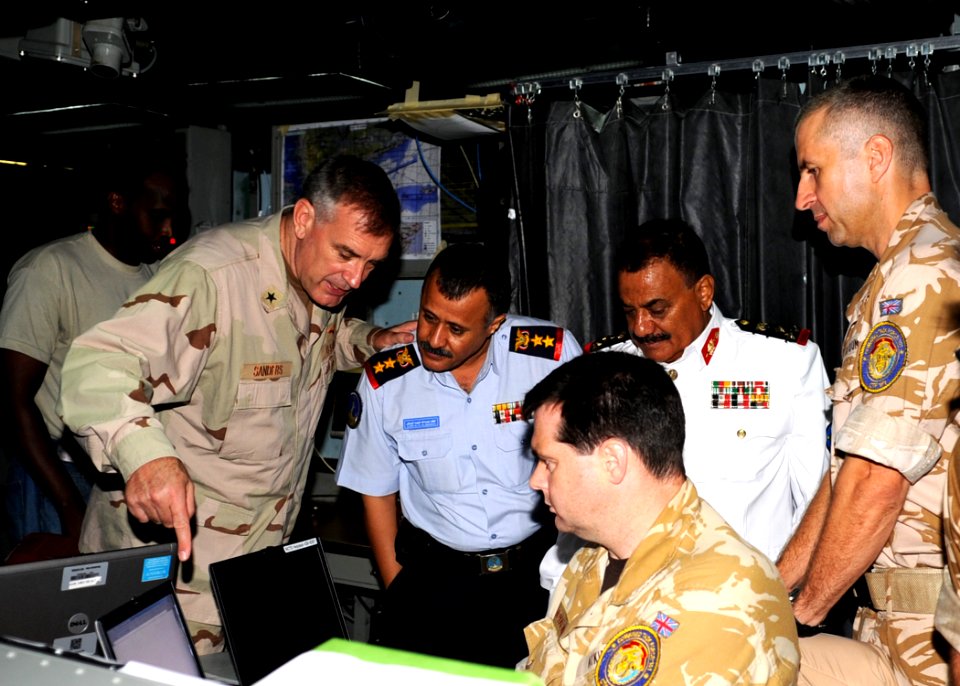 US Navy 090912-N-6814F-147 Rear Adm. Scott E. Sanders explains equipment to Col. Lofta Al Barati and Brig. Gen. Shamshan Radhan during a visit aboard the guided-missile cruiser USS Anzio (CG 68)