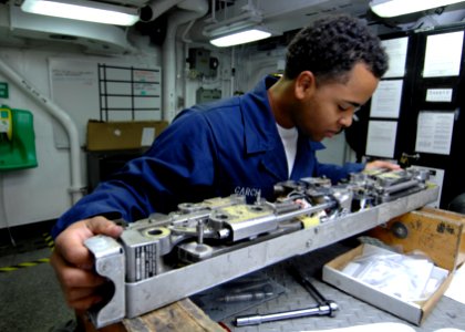 US Navy 090914-N-6003P-019 Aviation Ordnanceman Daniel Garcia, from Jacksonville, Fla., inspects the BRU-32 bomb rack of an F-A-18 strike fighter aboard the aircraft carrier USS Harry S. Truman (CVN 75)