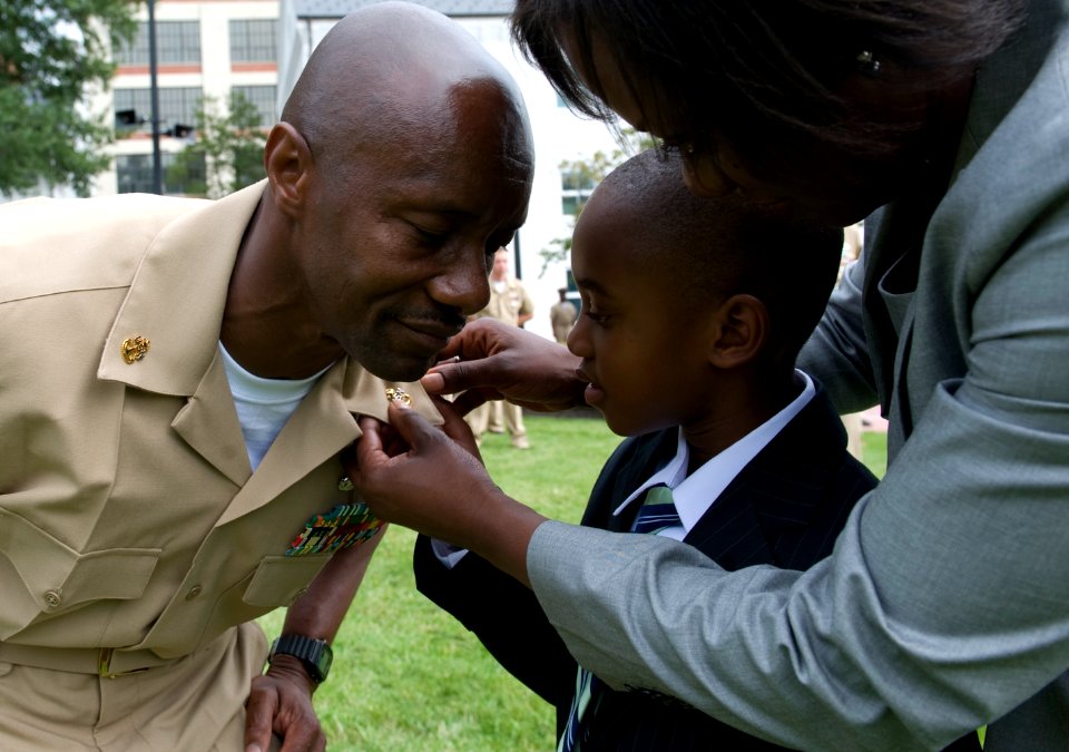 US Navy 090916-N-7090S-273 A chief petty officer has his anchors pinned by his wife and son during the 2009 chief petty officer pinning ceremony at the Washington Navy Yard