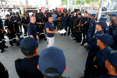 US Navy 090913-N-4936C-020 U.S. Coast Guard Lt. Cliff Harrison briefs military personnel from several nations during an FA PANAMAX 2009 maritime boarding training exercise