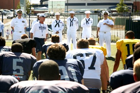 US Navy 090916-N-3271W-163 Christ Ault, head football coach for the University of Nevada Reno Wolf Pack introduces Cmdr. Marc Behning, left, commanding officer of the Ohio-class fleet ballistic-missile submarine USS Nevada (SSB