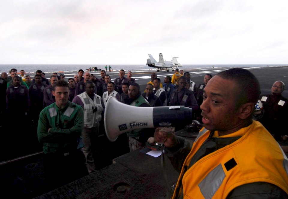 US Navy 090916-N-6538W-501 Ensign Kenyatto Mayes, from Atlanta, briefs air department Sailors before flight deck drills aboard the Nimitz-class aircraft carrier USS John C. Stennis (CVN 74)