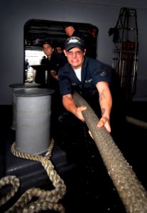 US Navy 090914-N-6538W-097 Seaman Kyle Albrecht, from St. Louis, Mo., heaves a mooring line as the Nimitz-class aircraft carrier USS John C. Stennis (CVN 74)