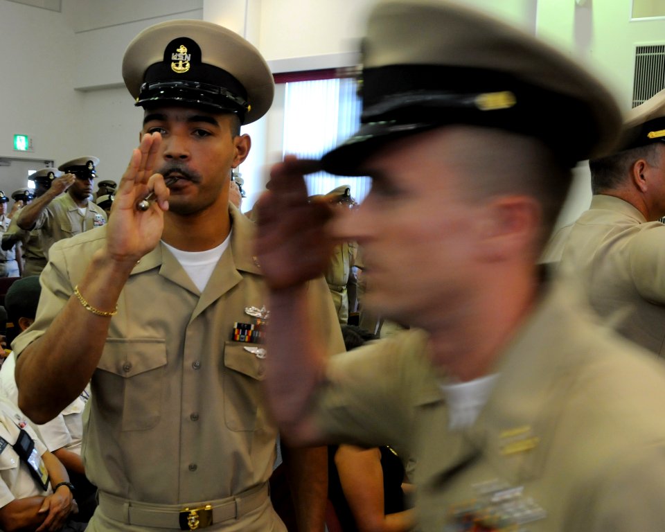 US Navy 090916-N-0120A-119 Chief Boatswain Mate Johan Zorilla, assigned to the forward deployed amphibious assault ship USS Essex (LHD 2), pipes aboard Chief Damage Controlman Jason Lobb