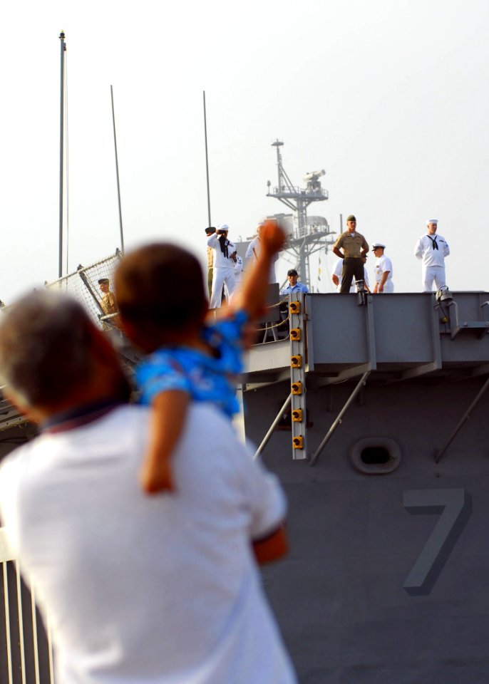 US Navy 090918-N-8607R-124 child waves good-bye to his mother as the amphibious transport dock ship USS Cleveland (LPD 7) departs Naval Base San Diego