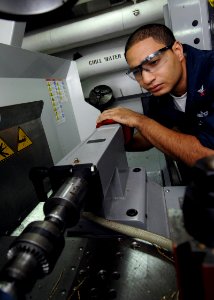 US Navy 090915-N-6003P-130 Machinery Repairman 2nd Class David Taylor, from Vallejo, Ca., lines up a pump shaft for center drilling aboard the aircraft carrier USS Harry S. Truman (CVN 75)