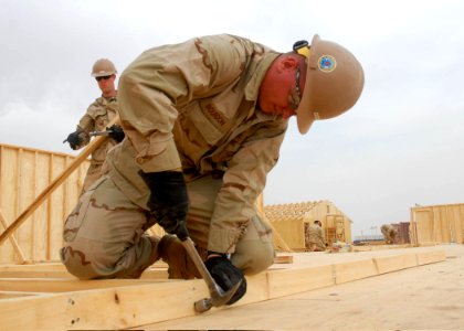 US Navy 090916-N-9564W-038 Construction Electrician Constructionman Matthew Bourdon, assigned to Naval Mobile Construction Battalion (NMCB) 74, builds a wall panel for a Southwest Asia Hut