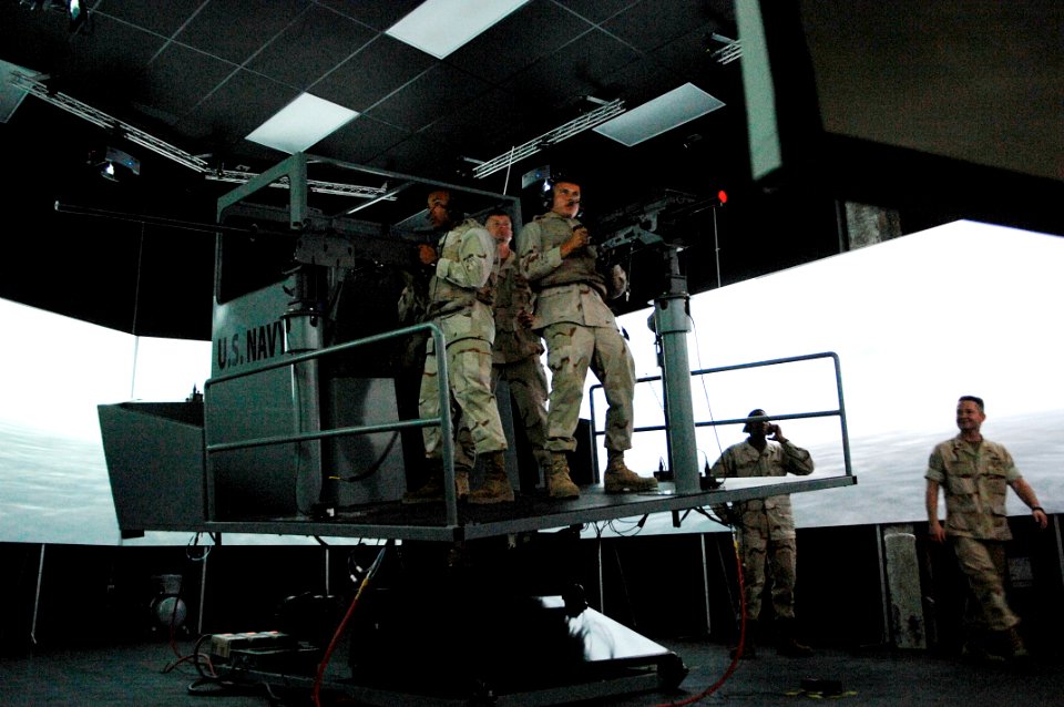 US Navy 090916-N-9818V-413 Master Chief Petty Officer of the Navy (MCPON) Rick West reviews the small boat simulator with Sailors from Commander Task Force (CTF) 56