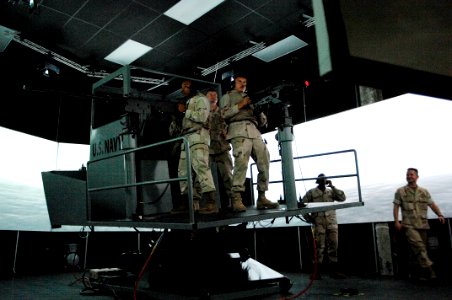US Navy 090916-N-9818V-413 Master Chief Petty Officer of the Navy (MCPON) Rick West reviews the small boat simulator with Sailors from Commander Task Force (CTF) 56