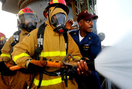 US Navy 090917-N-5345W-013 Chief Hull Maintenance Technician Jeffrey Middleton, right, trains fire team members on how to properly relieve the nozzleman during a general quarters drill