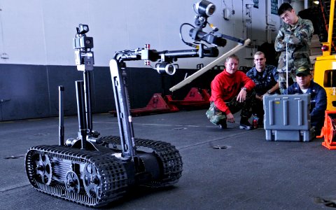 US Navy 090917-N-6003P-645 Machinist's Mate 2nd Class Gerardo Torres, from Los Angeles, Calif., remotely controls the Talon 4 Counter Improvised Explosive Device (IED) robot with guidance f photo