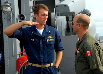 US Navy 090916-N-2821G-216 Ensign Eric Icke speaks with Peruvian navy Capt. de Corbetta Alex Arriaran Schaffer about flight operation capabilities of the Peruvian navy frigate BAP Quinones (FM 58)