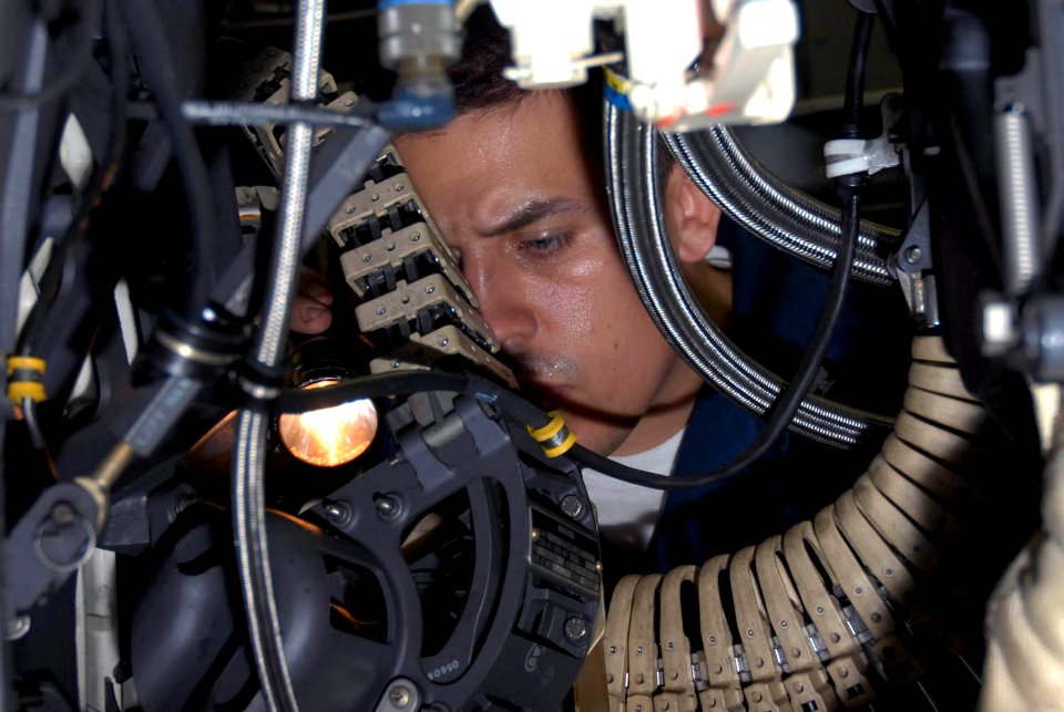 US Navy 090917-N-2600H-007 Aviation Ordnanceman 1st Class John Hardy visually inspects a 20mm Vulcan cannon from a F-A-18C Hornet aboard the aircraft carrier USS Nimitz (CVN 68)