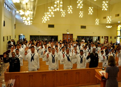 US Navy 090918-N-2013O-142 Service members and family members recite the oath of allegiance during a naturalization ceremony at Commander, Fleet Activities Yokosuka photo