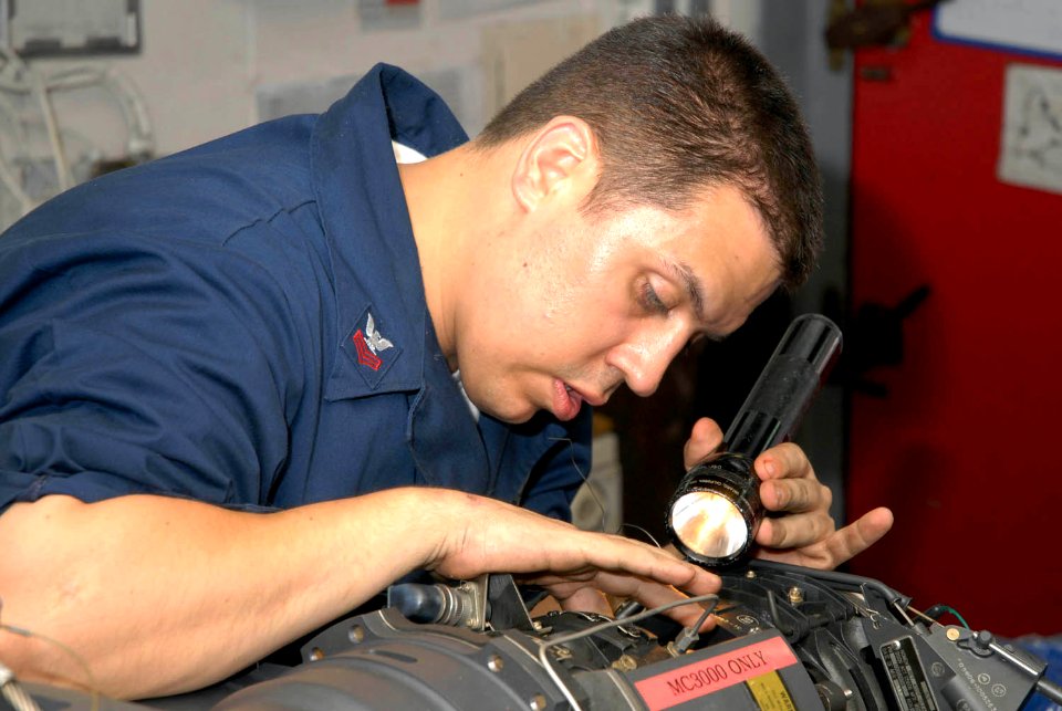 US Navy 090917-N-2600H-003 viation Ordnanceman 1st Class John Hardy visually inspects a 20mm Vulcan cannon from an F-A-18C Hornet aboard the aircraft carrier USS Nimitz (CVN 68). Nimitz and embarked Carrier Air Wing (CVW) 11