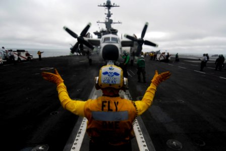 US Navy 090919-N-6538W-232 Aviation Boatswain's Mate (Handling) 3rd Class Scott Gray, from Salt Lake City, Utah, guides a C-2A Greyhound