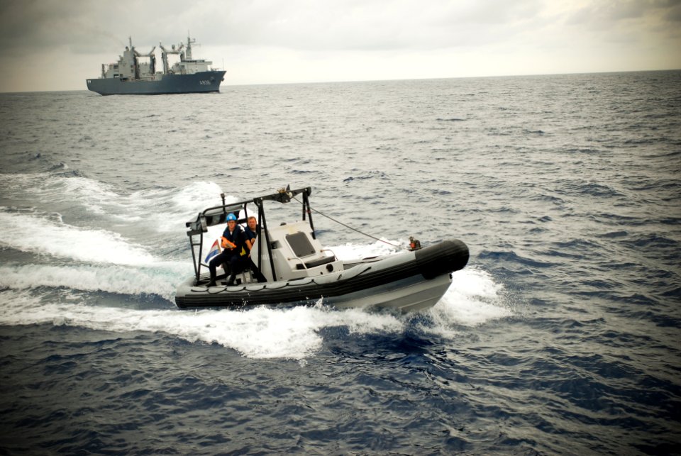 US Navy 090917-N-8590G-007 Sailors in a rigid hull inflatable boat from the Dutch navy fast combat support ship HNLMS Amsterdam (A386) approach a suspicious vessel to conduct a visit, board, search and seizure training scenario