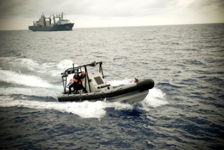 US Navy 090917-N-8590G-007 Sailors in a rigid hull inflatable boat from the Dutch navy fast combat support ship HNLMS Amsterdam (A386) approach a suspicious vessel to conduct a visit, board, search and seizure training scenario