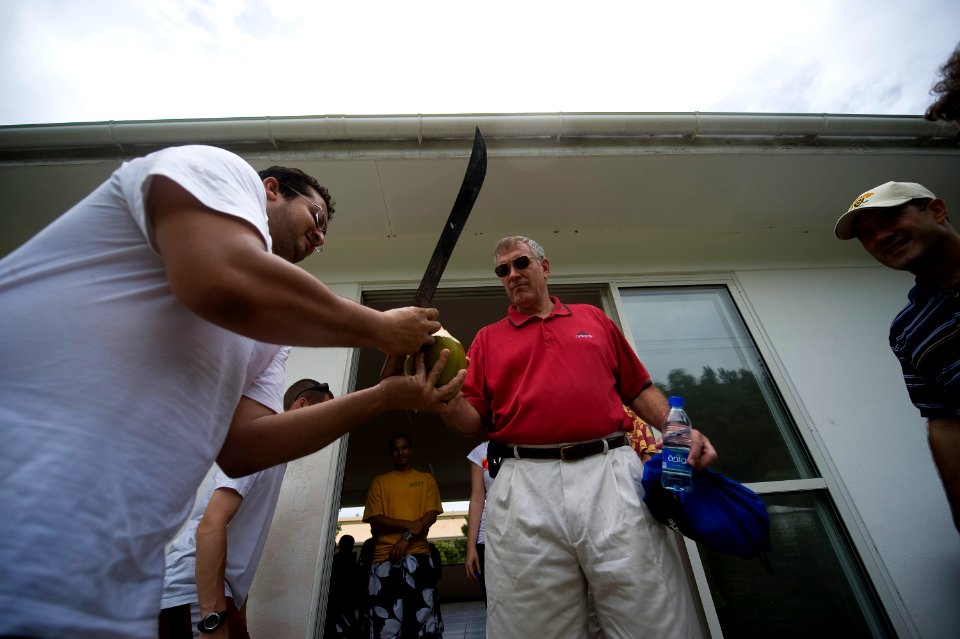 US Navy 090921-N-4154B-049 Rear Adm. (lower half) Scott E. Sanders, commander of Combined Task Force (CTF) 151, receives a coconut from one of the workers at a local rehabilitation clinic