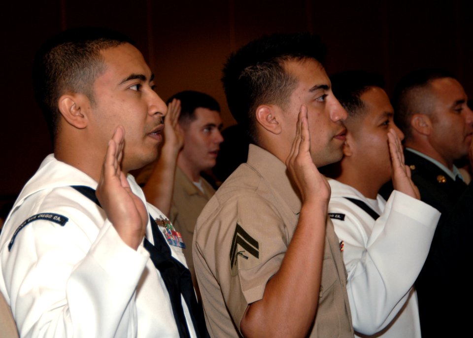 US Navy 090917-N-7214P-003 Culinary Specialist 3rd Class Kevin Chhuon and fellow Sailors, Marines and Soliders, raise their right hands to take the oath of allegiance during a naturalization ceremony at Camp Pendleton, Calif