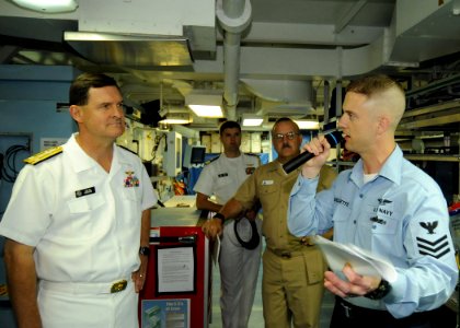 US Navy 090918-N-1062H-060 Aviation Technician 1st Class Scott Ouellette explains to Vice Adm. Dave Venlet, commander of Naval Air Systems Command, how the Aircraft Intermediate Maintenance Department operates aboard the aircra