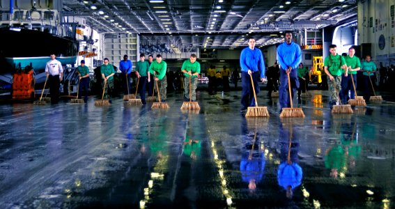 US Navy 090921-N-6003P-021 Sailors and Marines scrub jet and helicopter oil from the hangar bay of the aircraft carrier USS Harry S. Truman (CVN 75)