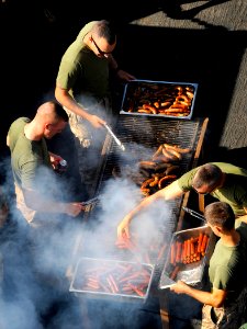 US Navy 090919-N-5345W-003 Marines from the 22nd Marine Expeditionary Unit (22nd MEU) man the grill during a steel beach picnic on the boat deck of the amphibious dock landing ship USS Fort McHenry (LSD 43)