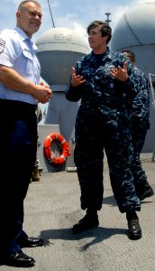US Navy 090919-N-4879G-157 Electronics Technician 1st Class Tiffany Mallory, right, explains the communication features of the ship to Chief Master Sgt. of the Air Force James A. Roy a