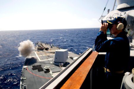 US Navy 090922-N-1251W-123 PACIFIC OCEAN (Sept. 22, 2009) Commanding Officer, Cmdr. H. B. Le, of the guided missile destroyer USS Lassen (DDG 82), observes the ship's five-inch gun
