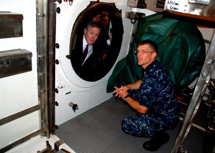 US Navy 090923-N-8750E-097 Secretary of the Navy (SECNAV) the Honorable Ray Mabus, looks into the lock-out chamber of the Virginia-class attack submarine USS New Hampshire (SSN 778) photo