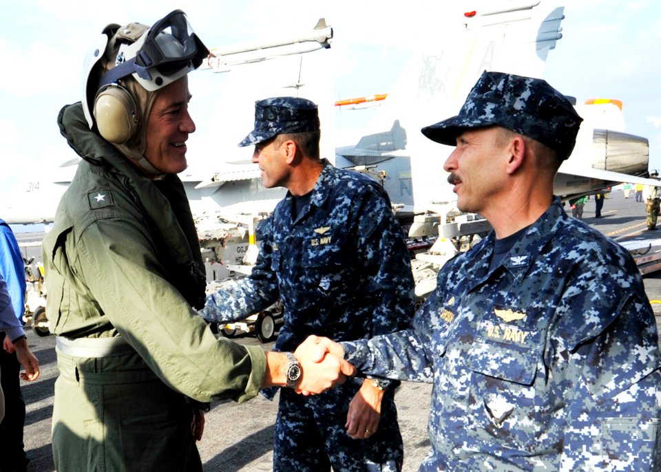 US Navy 090917-N-6003P-001 Rear Adm. Robert P. Wright, deputy commander of U.S. 2nd Fleet, greets Capt. Joseph M. Clarkson, commanding officer of the aircraft carrier USS Harry S. Truman (CVN 75) aboard the ship
