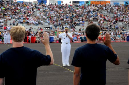 US Navy 090919-N-6220J-003 Rear Adm. Mark Fox, commander of the Naval Strike and Air Warfare Center, conducts a swearing-in ceremony for 27 local Delayed Entry Program enrollees at the Reno Air Races photo